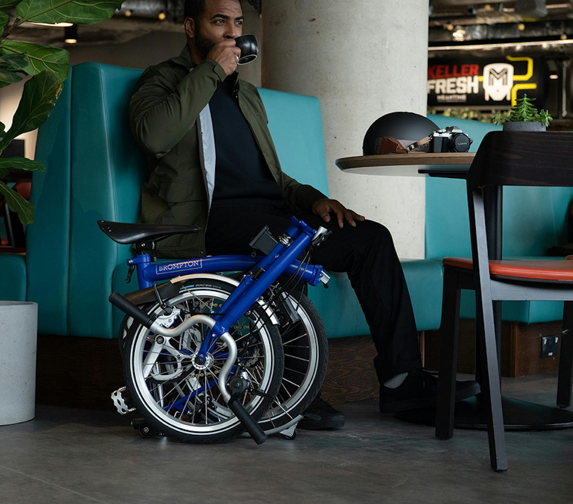 Blue brompton folded in cafe